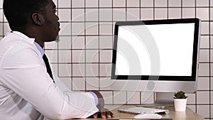 African doctor making video call with his computer. White Display.