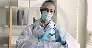 African doctor in mask show love sign gesture with fingers