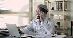 African doctor provides support to clinic client by phone call