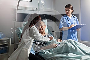 African doctor specialist using stethoscope listening senior man heart