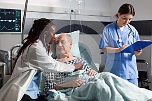African doctor specialist using stethoscope listening senior man heart