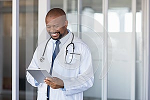 African doctor using digital tablet at hospital