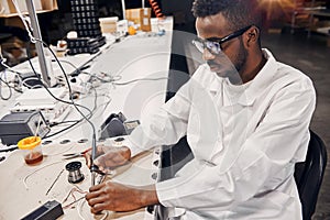 African engineer working manually with tools