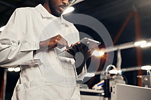 African engineer working with tablet at factory