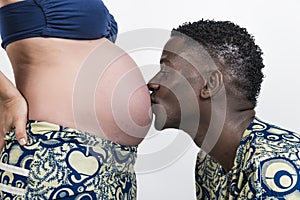 African ethnic man kiss Pregnant mother Caucasian woman