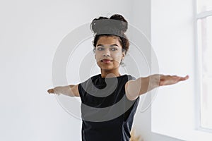 African ethnicity woman doing yoga or sport training at home