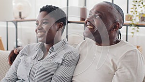 African family black married different ages, afro couple adult mature man husband and young ethnic wife sitting together