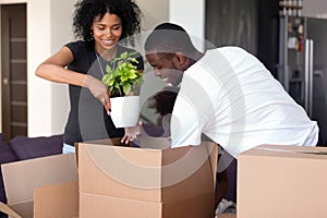 African family move at new home unpack belongings from boxes