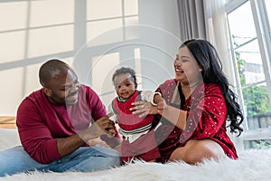 African family, Nigerian father and Asian mother holding a 4-month-old baby newborn son