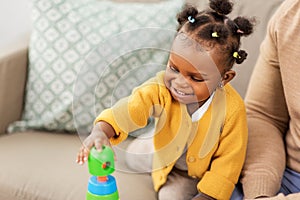 African family playing with baby daughter at home