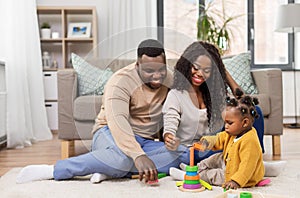 African family playing with baby daughter at home
