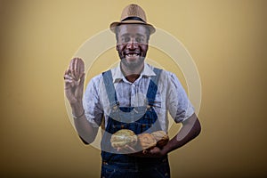 An African farmer holds cocoa beans in his hand, he is happy for the good harvest