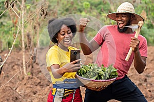 african farmers checking a phone see exciting news