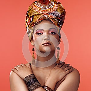 African fashion, beauty and portrait of woman on orange background with cosmetics, makeup and accessories. Glamour