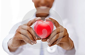 African female doctor with red heart