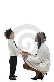 African female doctor and small boy is talking. Side view. Full length isolated