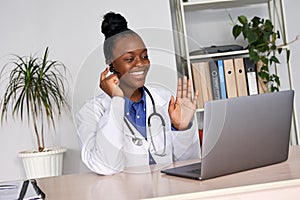 African female doctor talk to patient by telemedicine online webcam video call. photo