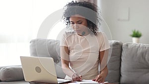 African female online teacher wearing headset teaching video calling