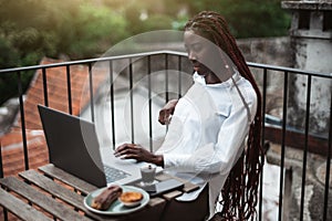 African female using laptop outdoors