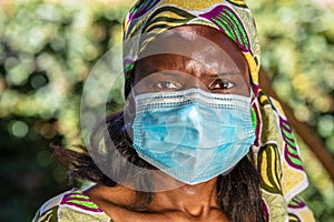 African female woman wearing face mask in Coronavirus COVID-19 pandemic