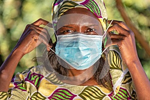 African female woman wearing face mask in Coronavirus COVID-19 pandemic