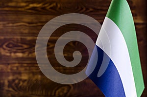 African flags Fragment of the flag of the Republic of Sierra Leone in the foreground space for text blurred background flag of the