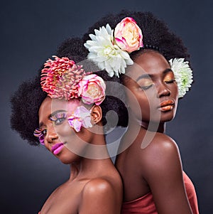 African, friends and beauty with flowers in makeup and art in dark background, studio and mockup. Floral, cosmetics and