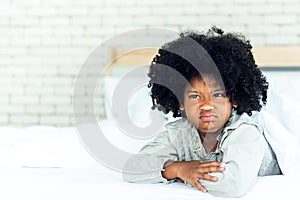 African girl 5-years old, Lying in the white bed Showing face Depicting anger and resentment