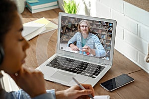 African girl college student studying with online teacher on computer screen.