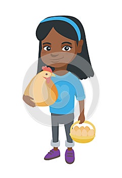 African girl holding a chicken and hen eggs.