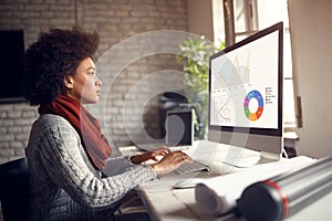 African girl at job working on computer