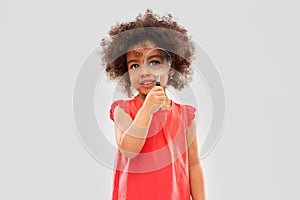 African girl looking through magnifying glass