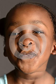 African girl pressing her face against a window