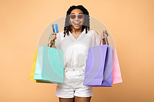 African Girl On Shopping Holding Credit Card, Beige Studio Background