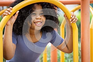 African girl smiling while playing at playground