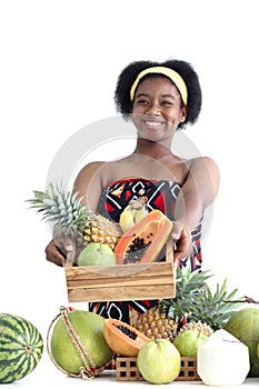 African girl teen with curly hair wearing traditional clothes, holding tropical basket fruits. Happy smiling African woman