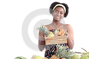 African girl teen with curly hair wearing traditional clothes, holding tropical basket fruits. Happy smiling African woman