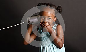 African girl with a tin and string on her ear