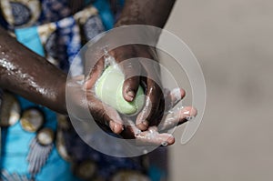 African Girl Washing Hands with Soap and Water