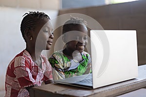 African Girls Looking at Laptop: New Technologies for the Future of Africa