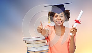 African graduate student with books and diploma