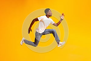 African guy jump, run fast, hurry up to sales or discounts