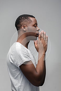 African guy praying God and asking for good things
