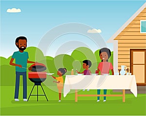 African Happy family preparing a barbecue grill outdoors. Family leisure