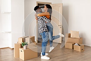 African Husband Holding Wife Among Moving Boxes Moving New Home