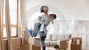 African husband lifting up wife happy family celebrating relocation day