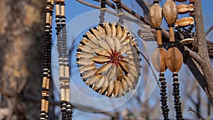 African jewelry made from seeds and beads shapped as flowers at an outdoor market in Namibia. Background is blurred or out of