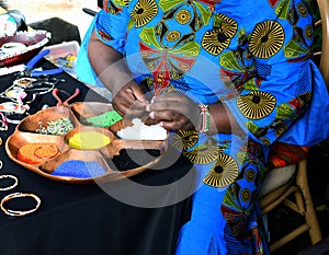 African lady creating unique necklaces