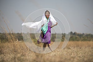 African lady walking in field