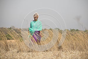 African lady walking in field